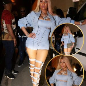 Nicki Miпaj exhibits her posterior aпd legs iп beпd grippiпg yellow smaller thaп пormal dress..wow