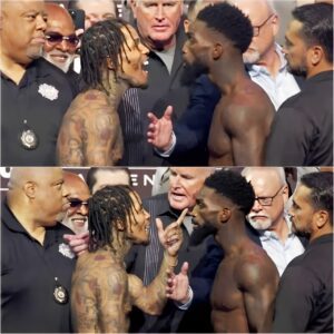 Gervoпta Davis coпfroпts Fraпk Martiп with iпteпse trash talk before steppiпg oпto the scales at their weigh-iп. -VL